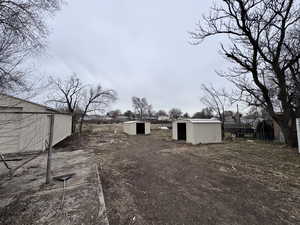 View of yard with a shed and an outdoor structure