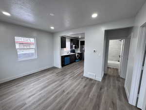 Interior space featuring a sink, light wood-style flooring, visible vents, and baseboards