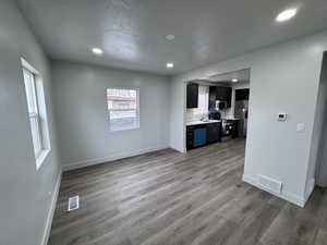 Interior space with stainless steel appliances, visible vents, and baseboards