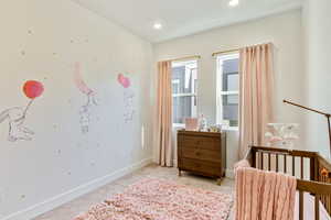 Bedroom with light carpet, baseboards, and recessed lighting