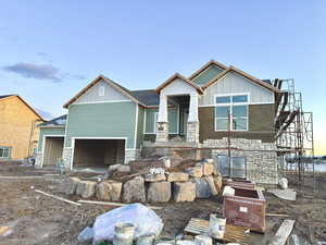 View of front of home with stone siding and board and batten siding