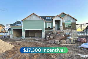 Craftsman-style home with stone siding, board and batten siding, and roof with shingles