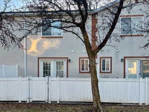 View of home's exterior featuring a fenced front yard, a gate, and stucco siding