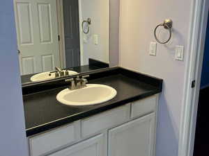 Bathroom with vanity and baseboards