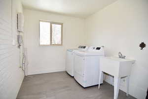 Washroom featuring laundry area, independent washer and dryer (gas or electric hook-ups for dryer and utility sink.