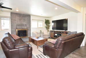 Great room featuring open design, brick fireplace and ceiling fan