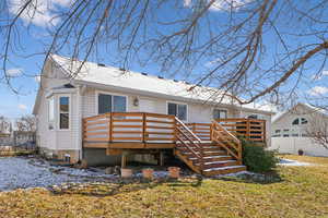 Rear view of property with fence and a wooden deck