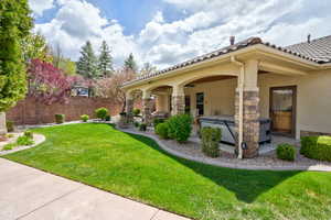 View of yard featuring a hot tub, fence, and a patio area