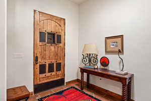 Tiled foyer entrance with baseboards