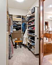 Walk in closet featuring carpet flooring