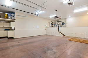Garage with baseboards and a garage door opener