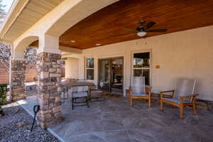 View of patio with outdoor dining area and a ceiling fan