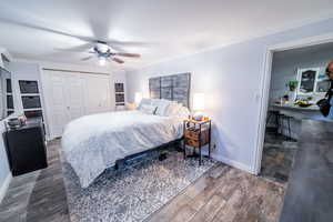 Bedroom with ornamental molding, a closet, baseboards, and wood finished floors