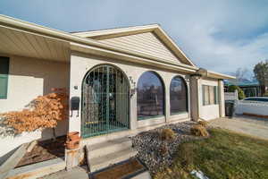 Doorway to property featuring brick siding