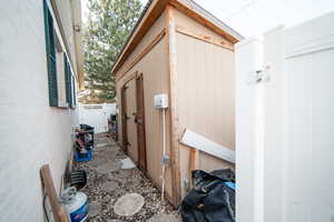 View of outbuilding featuring fence