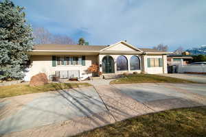 Single story home featuring roof with shingles and stucco siding