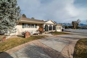 View of front of house featuring fence and brick siding