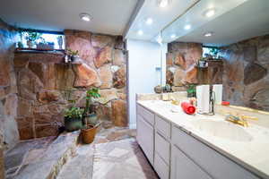 Full bath with a sink and double vanity