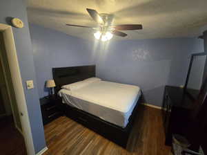 Bedroom featuring baseboards, a textured ceiling, a ceiling fan, and wood finished floors