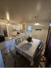 Dining room featuring visible vents, ceiling fan, dark tile patterned floors, and baseboards