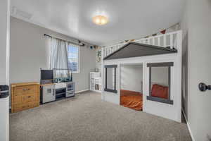 Bedroom featuring carpet floors, baseboards, and visible vents