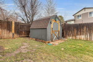 View of shed with a fenced backyard