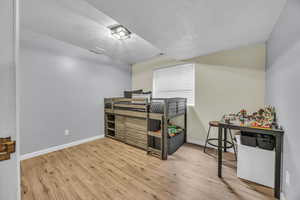 Interior space with visible vents, baseboards, and wood finished floors