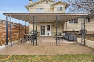 View of patio / terrace featuring fence, an outdoor living space, and central air condition unit