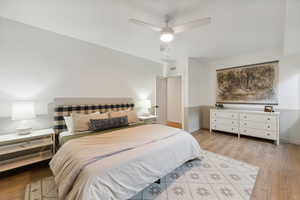 Bedroom featuring ceiling fan, wood finished floors, and baseboards
