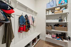 Mudroom featuring baseboards and wood finished floors