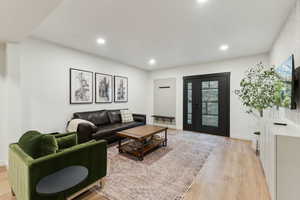 Living room featuring recessed lighting, light wood-style flooring, and baseboards