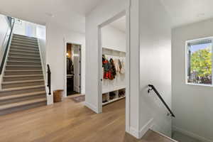 Stairway featuring baseboards and wood finished floors