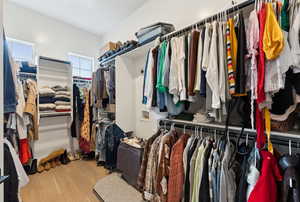 Walk in closet featuring wood finished floors