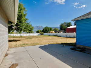 View of patio / terrace with fence and a mountain view