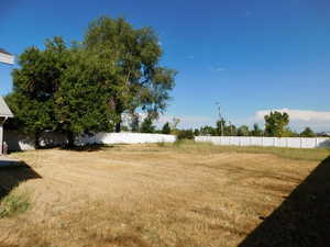 View of yard featuring fence