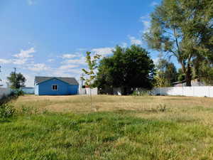 View of yard featuring fence