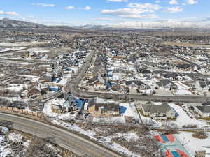 Snowy aerial view with a residential view and a mountain view