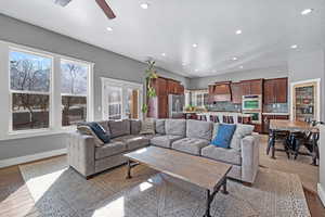 Living room featuring light wood-style floors, recessed lighting, french doors, and baseboards
