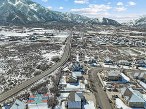 Snowy aerial view featuring a residential view and a mountain view