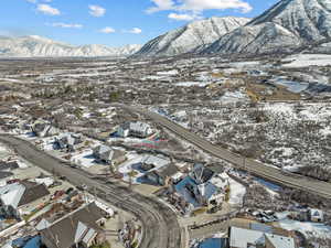 Snowy aerial view with a residential view and a mountain view
