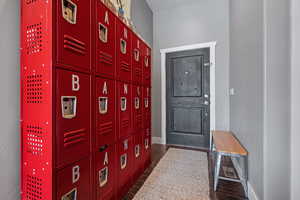 Entryway with dark wood-style floors and baseboards