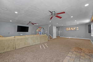 Unfurnished living room featuring a textured ceiling, stairway, carpet, and recessed lighting