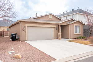 View of front of home featuring fence, roof with shingles, an attached garage, stucco siding, and concrete driveway