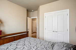 Carpeted bedroom with a closet and a textured ceiling