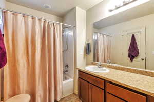 Bathroom featuring a  shower / tub combo, and vanity