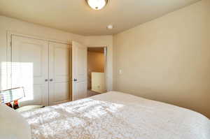 Secondary bedroom with carpet floors and a closet