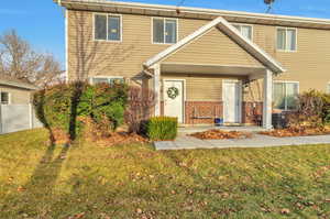 View of front of property with a front lawn and brick siding