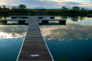 Dock area featuring a water and mountain view