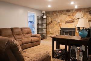 Living area with recessed lighting, a fireplace, and carpet floors