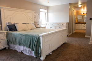 Main-floor Master bedroom with ensuite bathroom and carpet